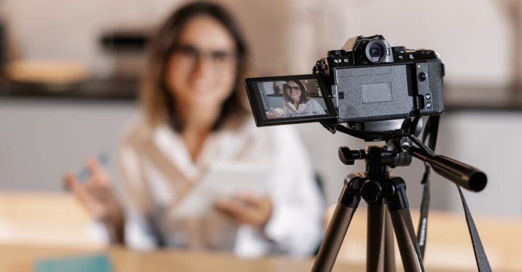 Woman vlogger using a camera and tripod for content creation indoors.