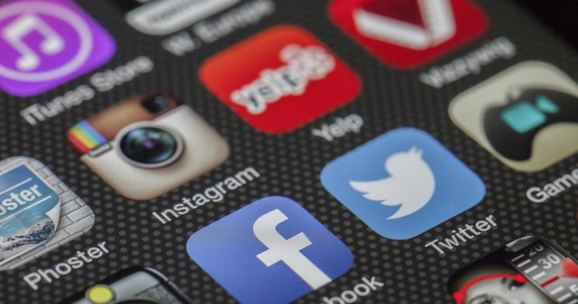 Close-up image of various social media app icons on a smartphone screen.